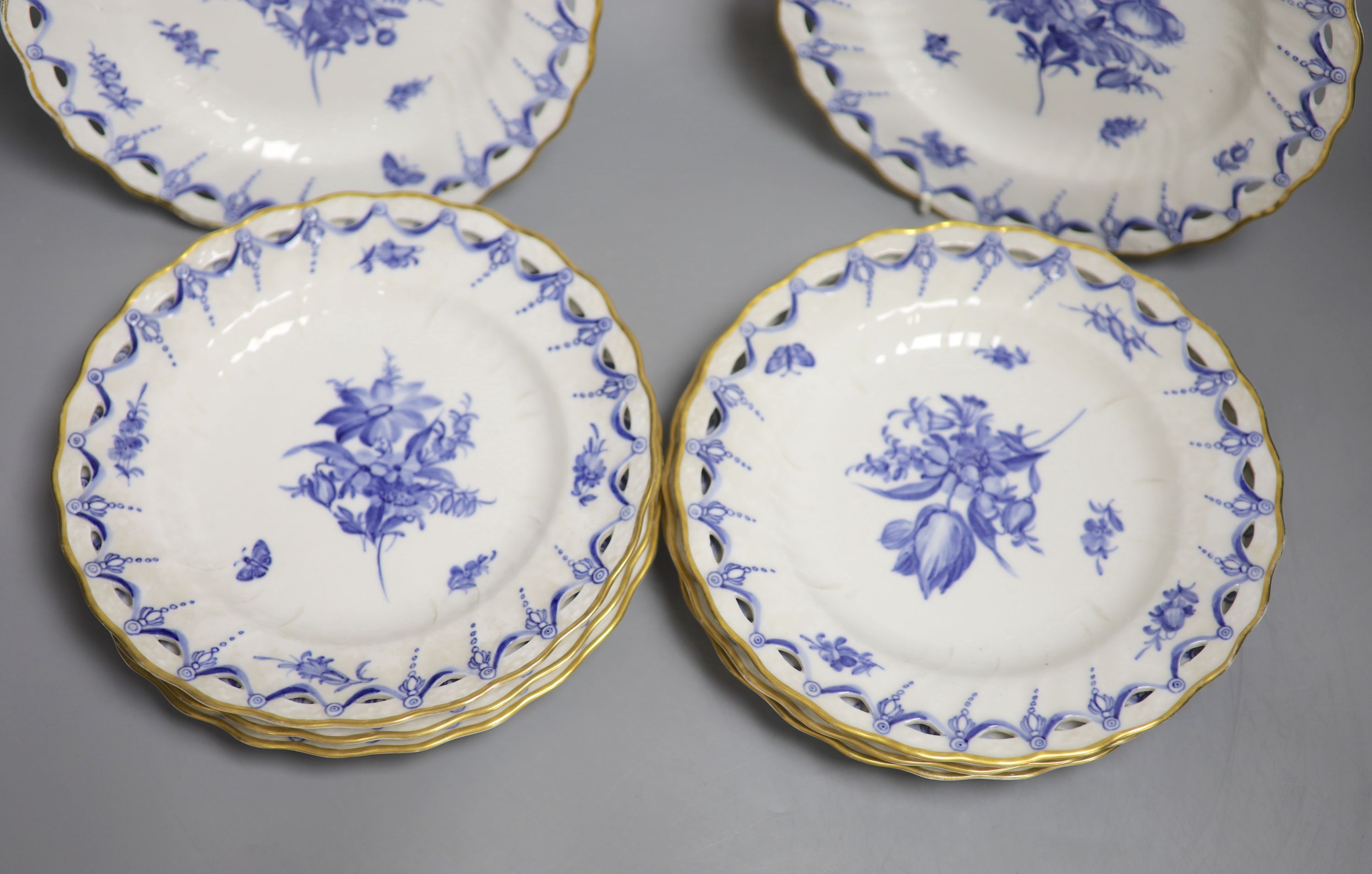 A set of eight Copenhagen plates, painted with flowers in underglaze blue surrounded by a pierced border, 1870-90, diameter 23cm